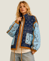 Women's Colbie Patchwork Bandana Quilted Jacket featuring a navy-green diamond-quilted body, baby blue sleeves, tan piping, and an adjustable drawstring waist.