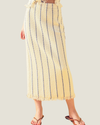 Cream knit midi skit with blue stripes and a fringe hem, part of a matching set. 