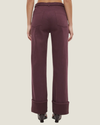 Women's mid-rise straight-leg cuff jeans featuring stretch denim, wide folded cuffs, contrast-buckle belt, and heavy topstitching.