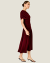 Women's Arabella Burgundy Maxi Dress featuring an asymmetrical off-the-shoulder neckline, ruched fitted bodice, and flowing skirt