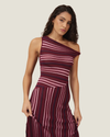 One-shoulder knit maxi dress with multi-directional stripes, twisted off-shoulder strap, and side leg split.