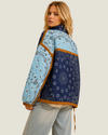 Women's Colbie Patchwork Bandana Quilted Jacket featuring a navy-green diamond-quilted body, baby blue sleeves, tan piping, and an adjustable drawstring waist.