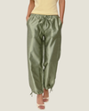 Women's taffeta drawstring pants with a relaxed fit, adjustable waist, tie-leg detailing, and patch pockets.