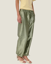 Women's taffeta drawstring pants with a relaxed fit, adjustable waist, tie-leg detailing, and patch pockets.