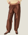 Women's taffeta drawstring pants with a relaxed fit, adjustable waist, tie-leg detailing, and patch pockets.