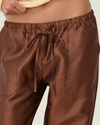 Women's taffeta drawstring pants with a relaxed fit, adjustable waist, tie-leg detailing, and patch pockets.