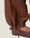 Women's taffeta drawstring pants with a relaxed fit, adjustable waist, tie-leg detailing, and patch pockets.