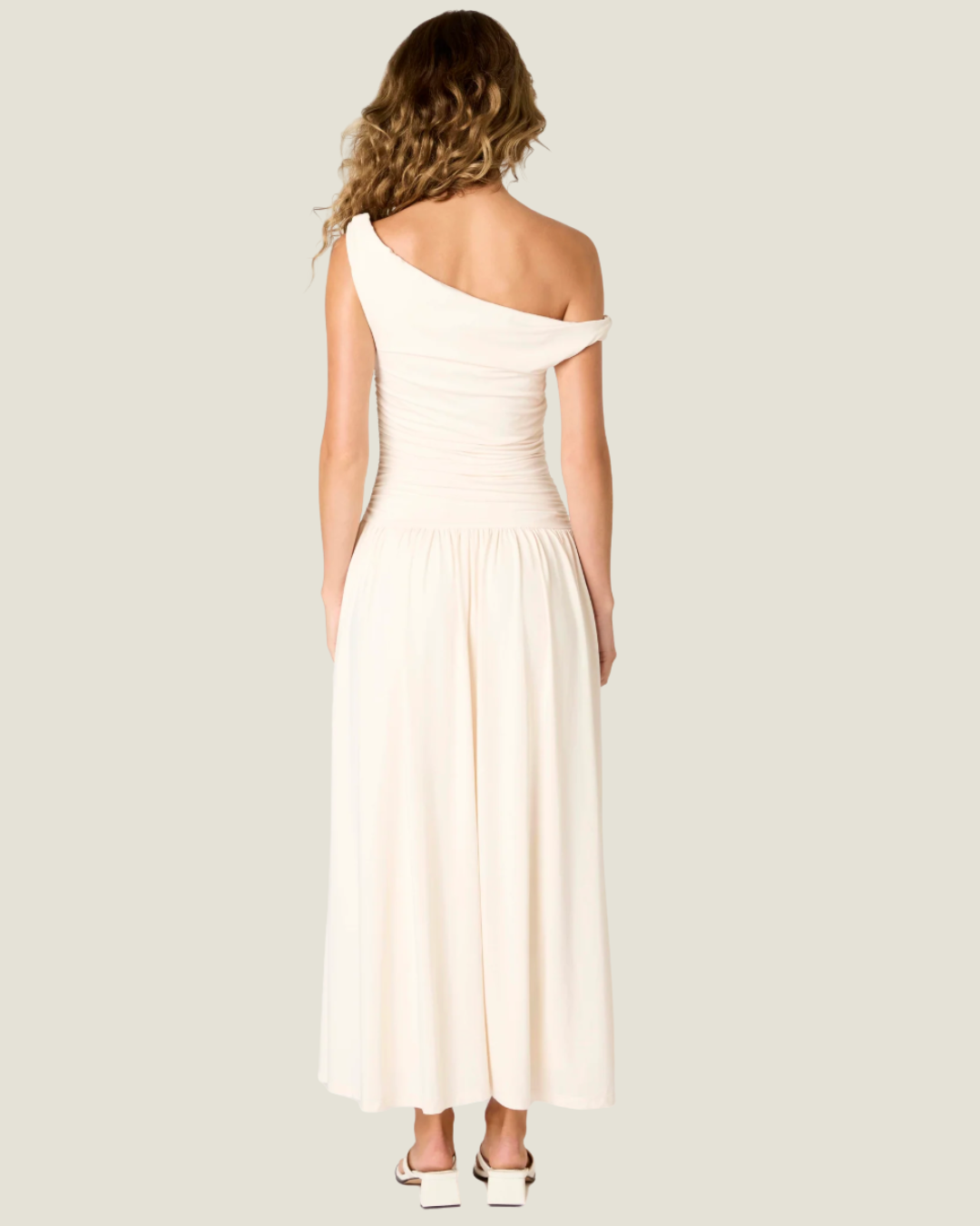 The Karina Dress Ecru Maxi Dress- a ruched bodice with drop waist NIA the brand.Available at Love Celine a women’s boutique in SWFL.