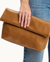 Angela tan vegan leather envelope crossbody bag with gold-tone hardware, detachable chain strap, and magnetic closure.