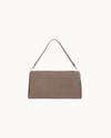 Fossil suede Vela shoulder bag with silver hardware detailing and a sleek, structured silhouette.