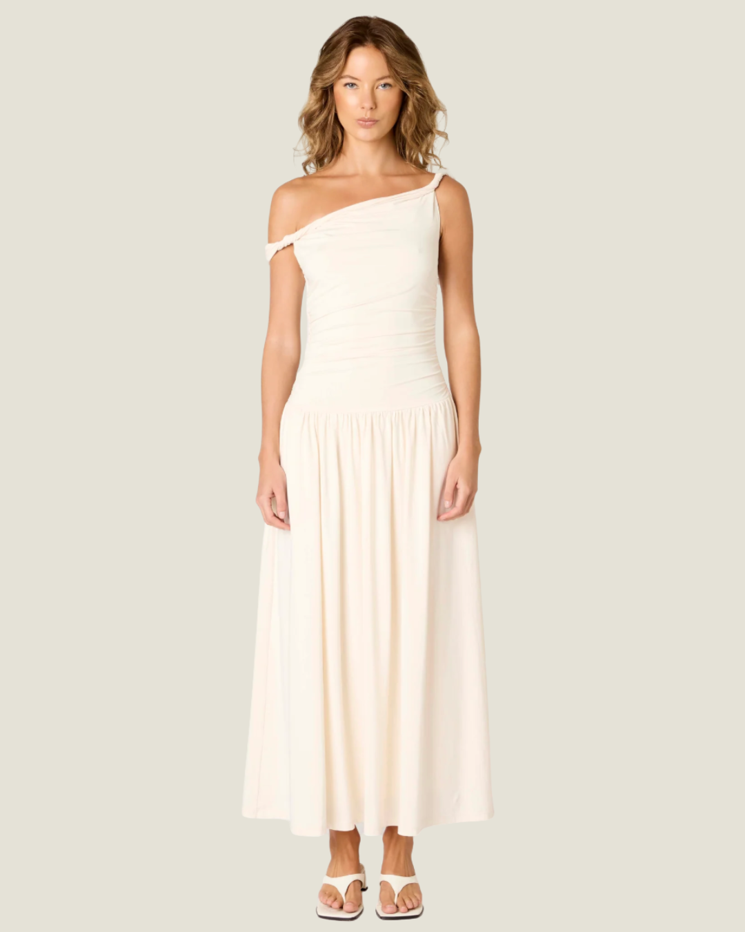 The Karina Dress Ecru Maxi Dress- a ruched bodice with drop waist NIA the brand.Available at Love Celine a women’s boutique in SWFL.