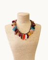 Handmade multicolor resin bead statement necklace with glossy earth-tone beads, mocha vegan suede cord, and vintage gold-plated hardware.