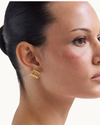 Heaven Mayhem Clemmie gold stud earrings featuring a ribbed texture, curved silhouette, and polished 18k gold PVD plating.