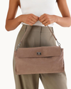 Fossil suede Vela shoulder bag with silver hardware detailing and a sleek, structured silhouette.