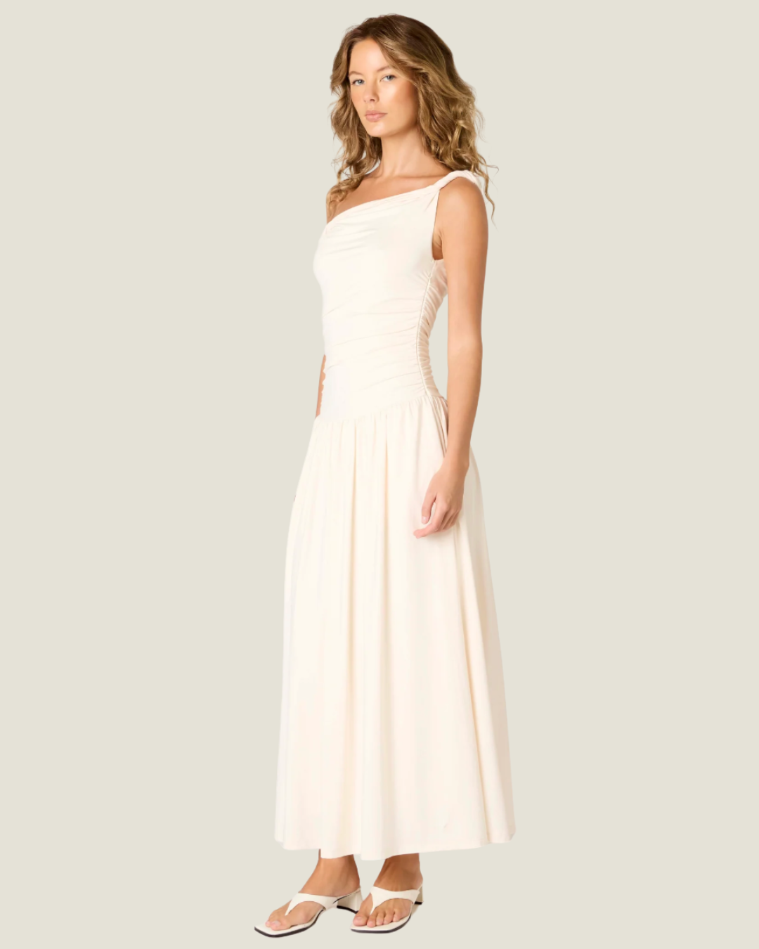 The Karina Dress Ecru Maxi Dress- a ruched bodice with drop waist NIA the brand.Available at Love Celine a women’s boutique in SWFL.