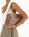 Fossil suede Vela shoulder bag with silver hardware detailing and a sleek, structured silhouette.