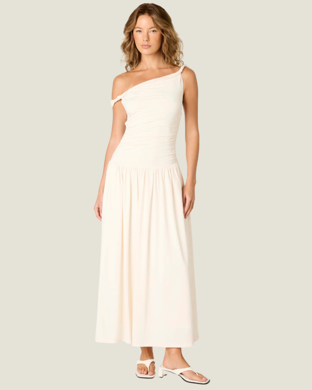 The Karina Dress Ecru Maxi Dress- a ruched bodice with drop waist NIA the brand.Available at Love Celine a women’s boutique in SWFL.