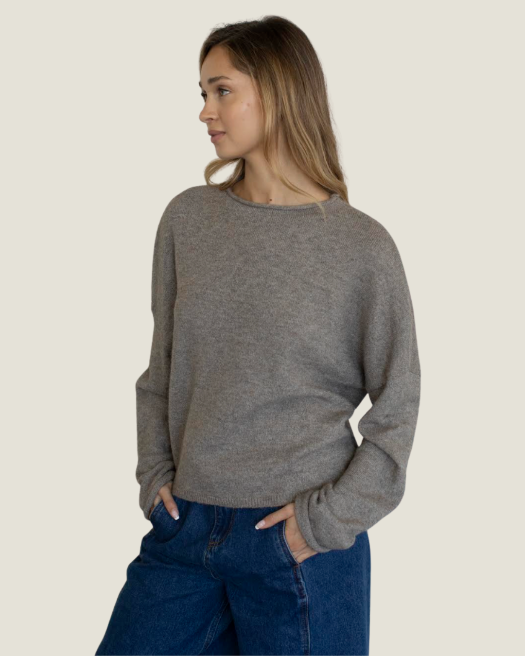 Mocha knit slightly oversized sweater with rolled neckline.