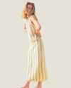 Cream knit midi skit with blue stripes and a fringe hem, part of a matching set. 