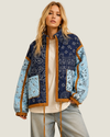 Women's Colbie Patchwork Bandana Quilted Jacket featuring a navy-green diamond-quilted body, baby blue sleeves, tan piping, and an adjustable drawstring waist.
