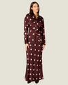 Women's polka dot satin button-up top with a collared neckline, shell buttons, long sleeves, and adjustable lace-up corset back