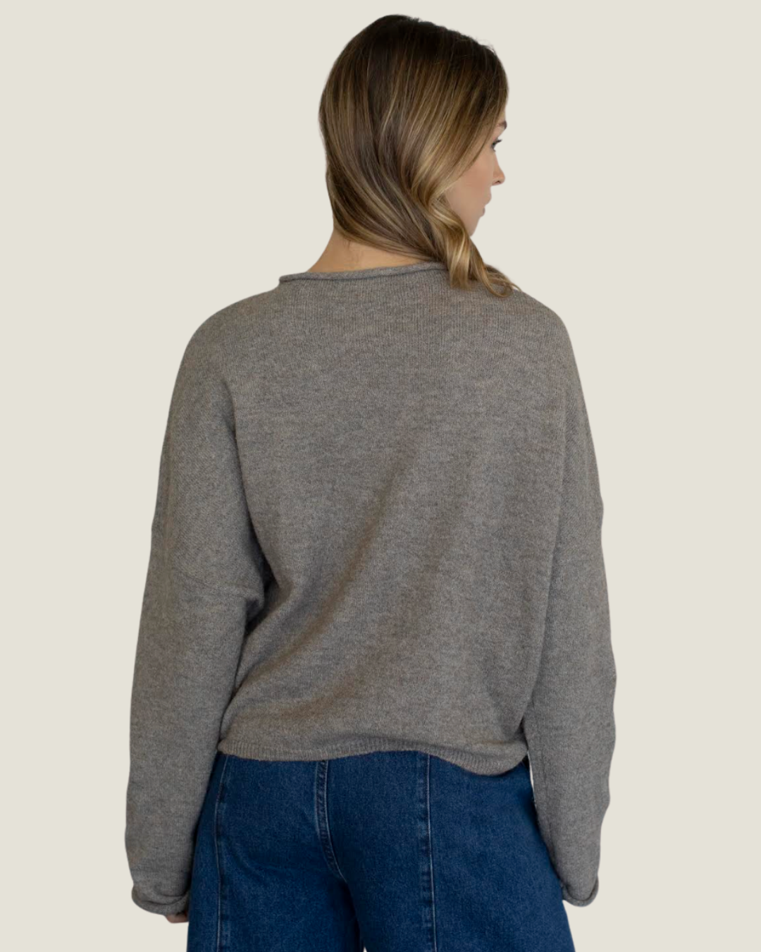 Mocha knit slightly oversized sweater with rolled neckline. 