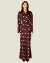 Women's polka dot satin button-up top with a collared neckline, shell buttons, long sleeves, and adjustable lace-up corset back