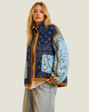 Women's Colbie Patchwork Bandana Quilted Jacket featuring a navy-green diamond-quilted body, baby blue sleeves, tan piping, and an adjustable drawstring waist.