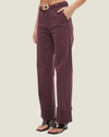 Women's mid-rise straight-leg cuff jeans featuring stretch denim, wide folded cuffs, contrast-buckle belt, and heavy topstitching.