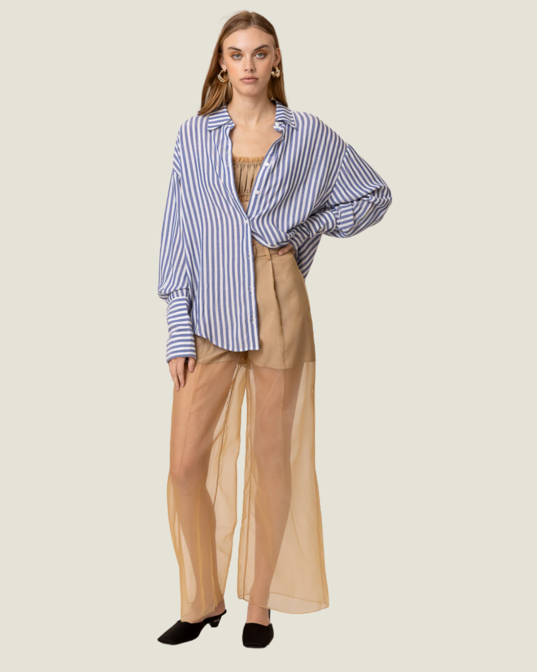 These Elfreda Sheer Overlay Wide Leg Pants are modern capsule wardrobe pieces, that feature a sheer bottom, high waist, and belt loops.