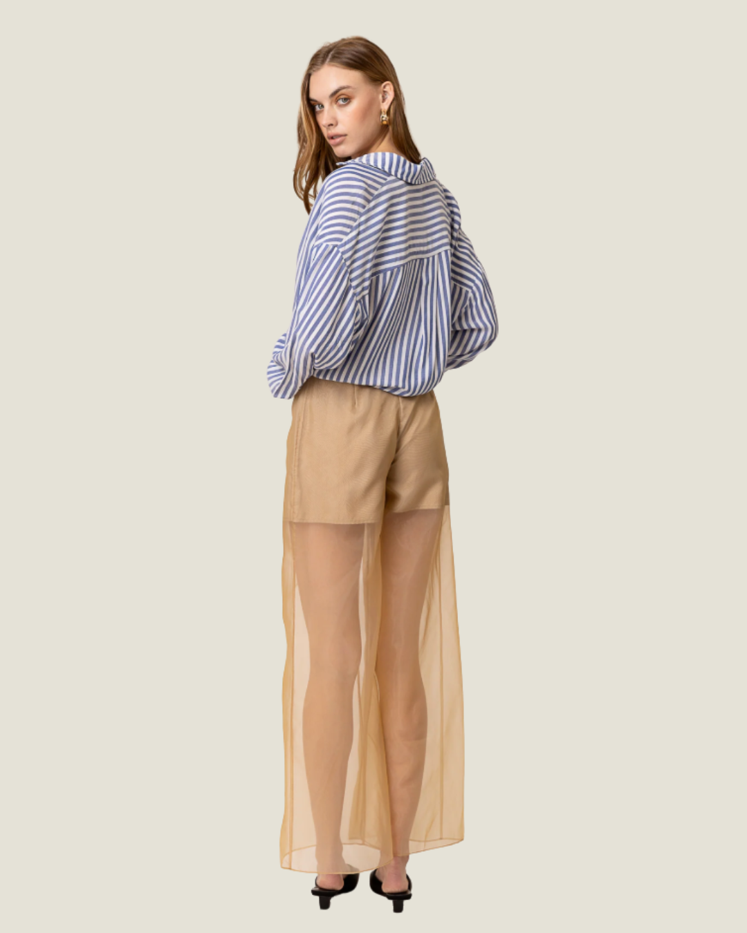 These Elfreda Sheer Overlay Wide Leg Pants are modern capsule wardrobe pieces, that feature a sheer bottom, high waist, and belt loops.