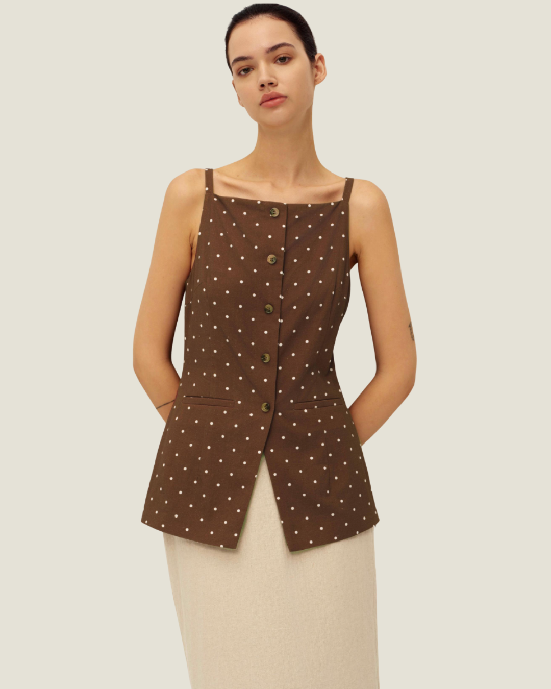 The Elise Polka Dot Top is designed with a square neckline, button down front, polka dots, and front v-neck it is a timeless women’s wardrobe staples.