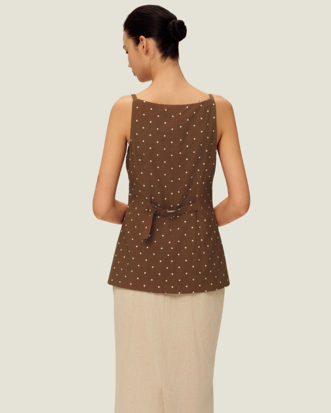 The Elise Polka Dot Top is designed with a square neckline, button down front, polka dots, and front v-neck it is a timeless women’s wardrobe staples.