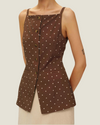 The Elise Polka Dot Top is designed with a square neckline, button down front, polka dots, and front v-neck it is a timeless women’s wardrobe staples.