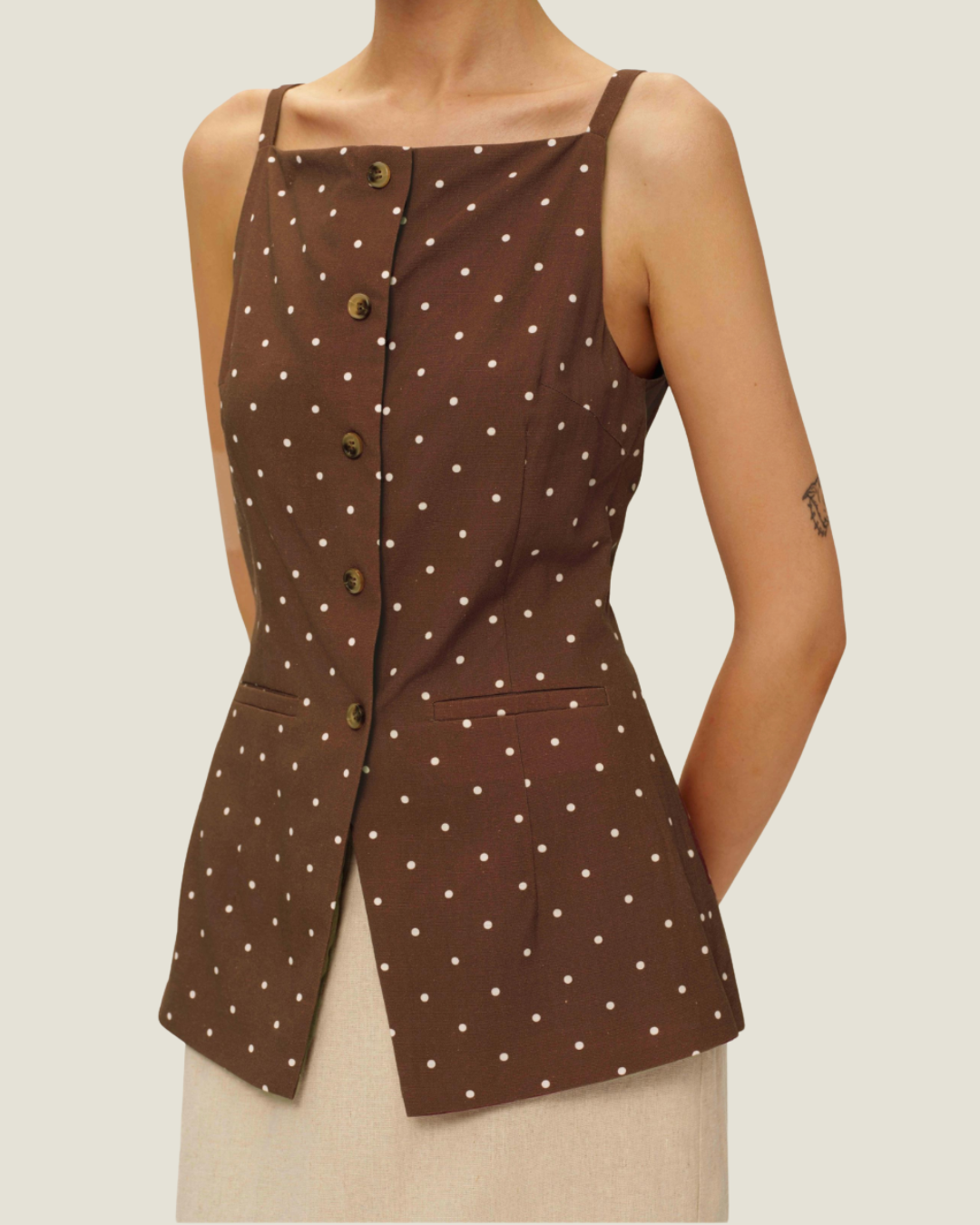 The Elise Polka Dot Top is designed with a square neckline, button down front, polka dots, and front v-neck it is a timeless women’s wardrobe staples.